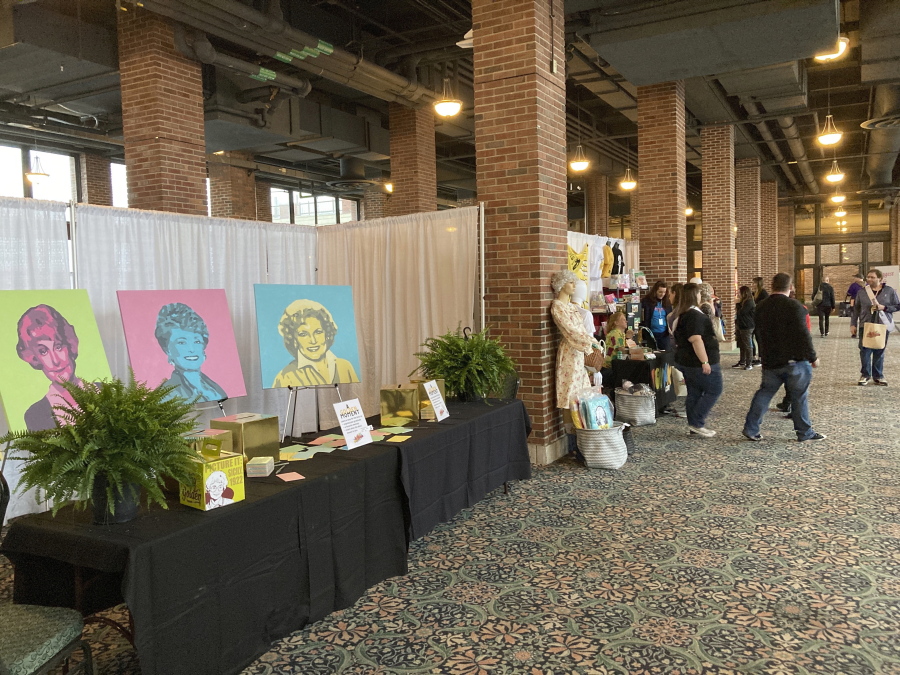 Attendees walk around a vendors' market at the first ever "The Golden Girls" fan convention Friday, April 22, 2022, at the Navy Pier in Chicago. Golden-Con, which lasts thru Sunday, is giving those who adored the NBC sitcom a chance to mingle, see panels and buy merchandise. The show, which ran from 1985-1992, starred Bea Arthur, Rue McClanahan, Estelle Getty and Betty White--who died at age 99 in December.