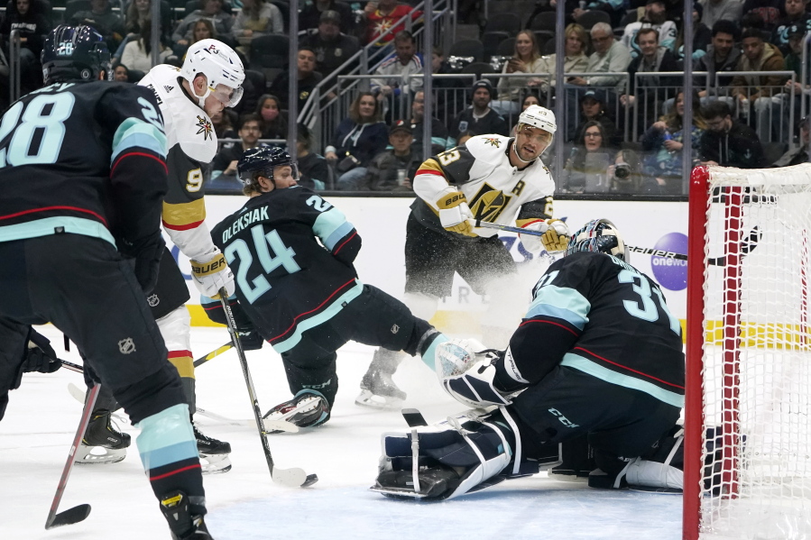 Vegas Golden Knights' Jack Eichel (9) scores on Seattle Kraken goalie Philipp Grubauer during the first period of an NHL hockey game Friday, April 1, 2022, in Seattle.