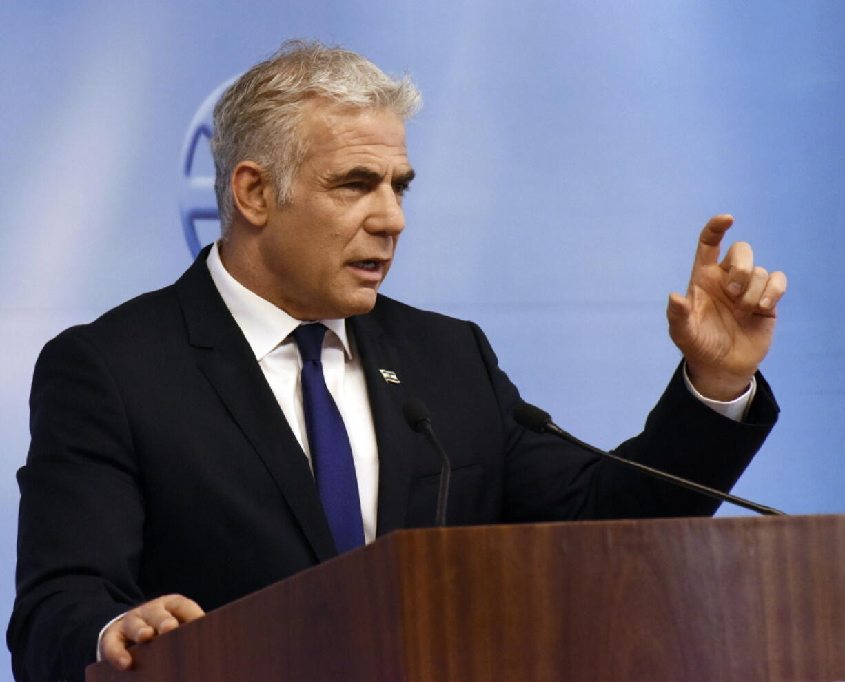 Israeli Foreign Minister Yair Lapid gives a press briefing at the foreign ministry in Jerusalem, Sunday, April 24, 2022.
