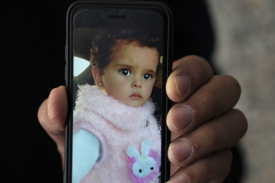 Jalal al-Masri holds a picture of his daughter, Fatma, a 19-month-old who was diagnosed with a congenital heart defect in December 2021, and died as the family waited another three months for an Israeli permit to take her for treatment outside the Gaza Strip, in Khan Younis, southern Gaza Strip, Tuesday, April 12, 2022. The death of  Fatma has shone a light on the struggles faced by Palestinians from the isolated territory who require urgent medical care. Israel and Egypt have imposed a blockade on Gaza since the Islamic militant group Hamas seized power there nearly 15 years ago.