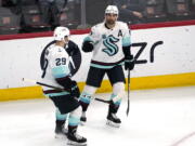 Seattle Kraken right wing Jordan Eberle, right, celebrates with defenseman Vince Dunn after scoring a goal against the Chicago Blackhawks during the third period of an NHL hockey game in Chicago, Thursday, April 7, 2022. The Kraken won 2-0. (AP Photo/Nam Y.