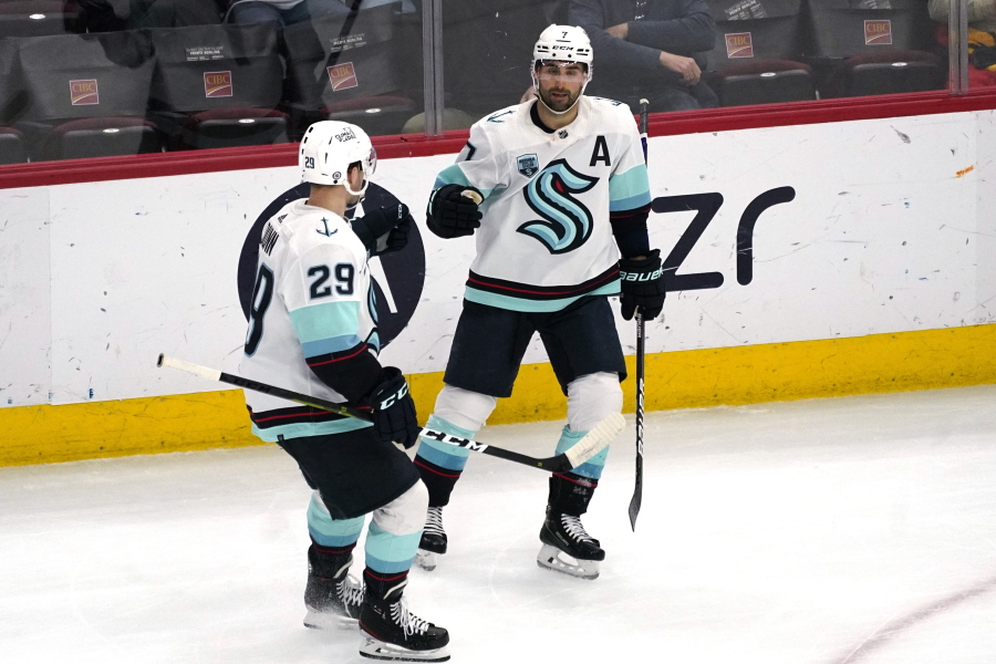 Seattle Kraken right wing Jordan Eberle, right, celebrates with defenseman Vince Dunn after scoring a goal against the Chicago Blackhawks during the third period of an NHL hockey game in Chicago, Thursday, April 7, 2022. The Kraken won 2-0. (AP Photo/Nam Y.