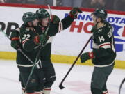 Minnesota Wild center Joel Eriksson Ek (14) looks to teammates after scoring a goal against the Seattle Kraken during the first period of an NHL hockey game, Friday, April 22, 2022, in St. Paul, Minn.