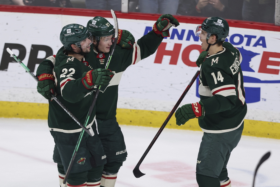 Minnesota Wild center Joel Eriksson Ek (14) looks to teammates after scoring a goal against the Seattle Kraken during the first period of an NHL hockey game, Friday, April 22, 2022, in St. Paul, Minn.