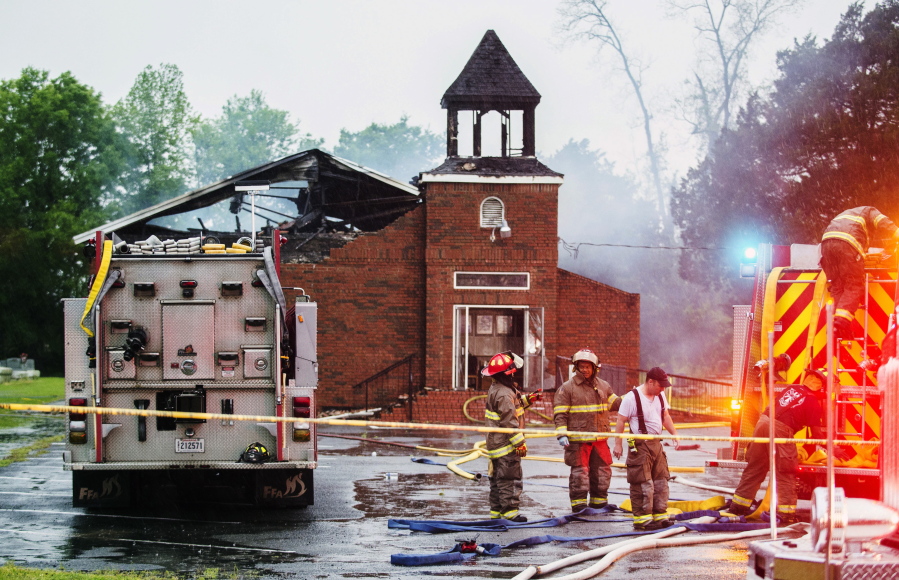 FILE - In this April 4, 2019, file photo, firefighters and fire investigators respond to a fire at Mount Pleasant Baptist Church, in Opelousas, La.  Three years after an arsonist torched three small Black churches in rural Louisiana, rebuilding is well under way. The Daily World reports, Tuesday, April 19, 2022,  that Mount Pleasant Baptist Church is months from reopening. And there's visible progress at St. Mary Baptist Church in Port Barre and Greater Union Baptist Church in Opelousas.