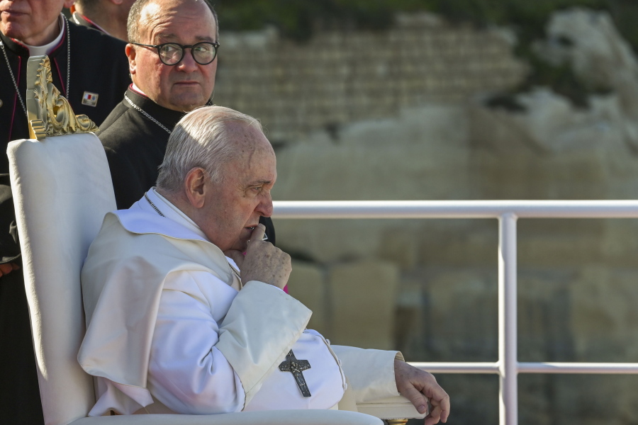 Pope Francis sits next to Malta's Archbishop Charles Jude Scicluna, left, aboard a catamaran leaving Valletta's harbor for Gozo in Malta Saturday, April 2, 2022. Pope Francis headed to the Mediterranean island nation of Malta on Saturday for a pandemic-delayed weekend visit, aiming to draw attention to Europe's migration challenge that has only become more stark with Russia's invasion of Ukraine.