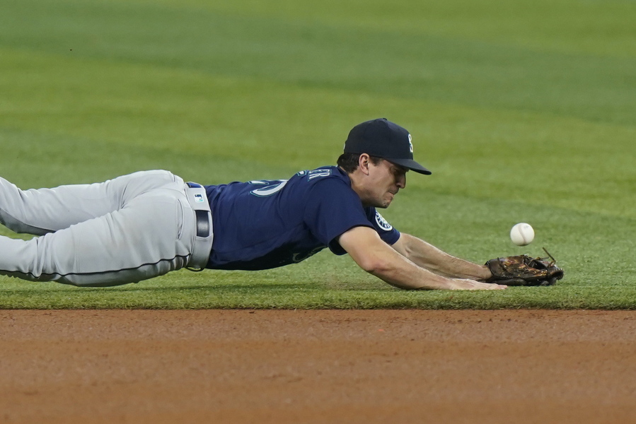 Seattle Mariners second baseman Adam Frazier is unable to catch a ball hit by Miami Marlins' Jesus Aguilar during the first inning Friday in Miami.