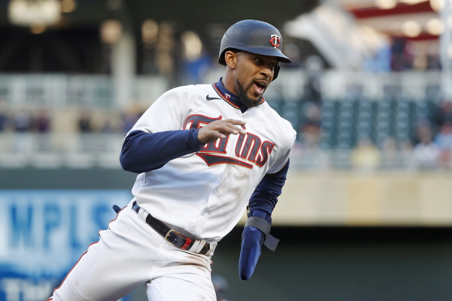 Minnesota Twins' Byron Buxton rounds third base en route to scoring against the Seattle Mariners on a double by Jorge Polanco in the first inning of a baseball game Monday, April 11, 2022, in Minneapolis.
