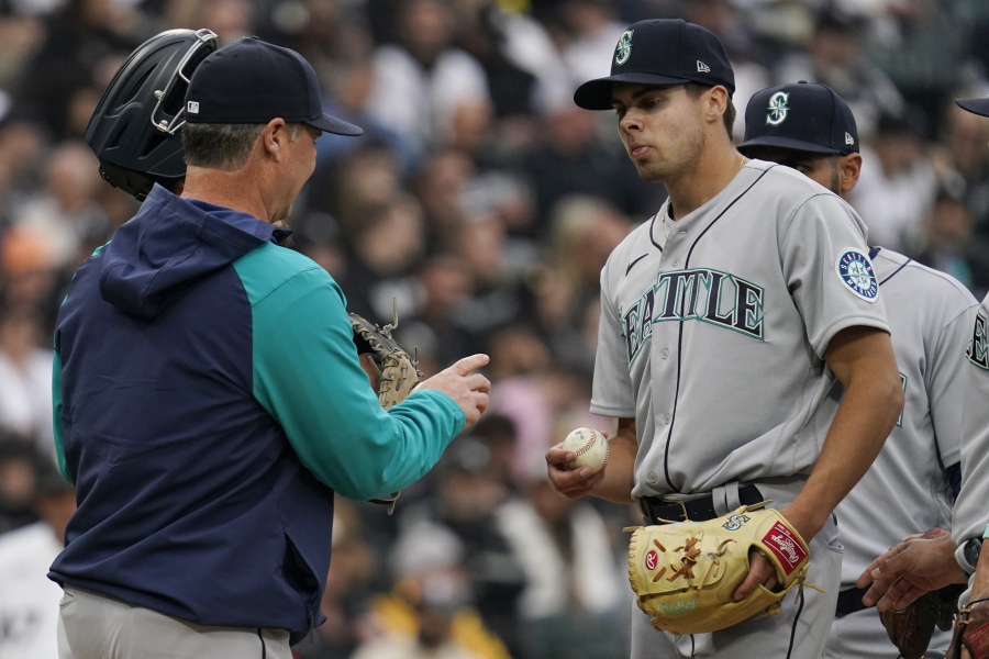 Seattle Mariners manager Scott Servais, left, takes the ball from starting pitcher Matt Brash during the sixth inning of the team's baseball game against the Chicago White Sox in Chicago, Tuesday, April 12, 2022. (AP Photo/Nam Y.