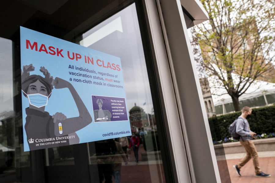 Signs indicating that protective face masks must be worn in classrooms are displayed outside lecture halls at Columbia University, Thursday, April 21, 2022, in the Manhattan borough of New York.