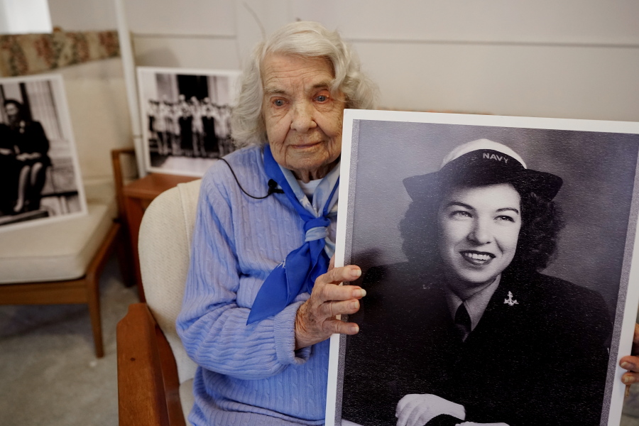 World War II veteran Ethel (Cricket) Poland holds a photo of her younger self during an interview, Monday, April 4, 2022, in Oakland Township, Mich. Poland, who has lived in Michigan since the 1960s, served for three years in Washington, D.C., as part of the WAVES (Women Accepted for Volunteer Emergency Service) program. "Although my part in the war was very small, I feel that it was worthwhile," said Poland, who planned to be in attendance for Thursday's ground breaking ceremony for The Michigan WWII Legacy Memorial in Royal Oak, Mich.