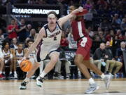Gonzaga forward Drew Timme, left, drives to the basket against Arkansas guard Stanley Umude during the second half of a college basketball game in the Sweet 16 round of the NCAA tournament in San Francisco, Thursday, March 24, 2022.