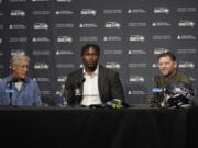Seattle Seahawks first-round draft pick Charles Cross sits with Seahawks head coach Pete Carroll, left, and general manager John Schneider, right, Friday in Renton. (Ted S.
