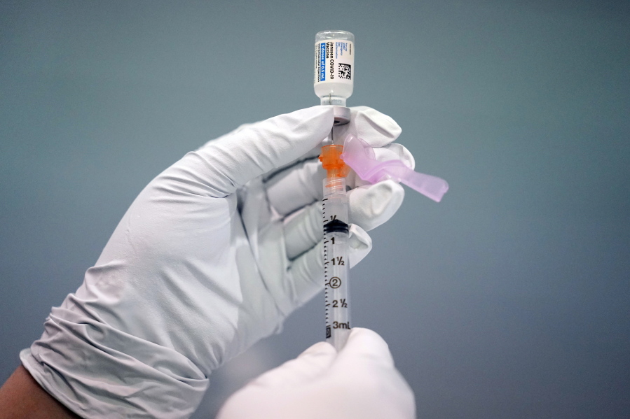 FILE - A member of the Philadelphia Fire Department prepares a dose of the Johnson & Johnson COVID-19 vaccine at a vaccination site setup in Philadelphia, on March 26, 2021.