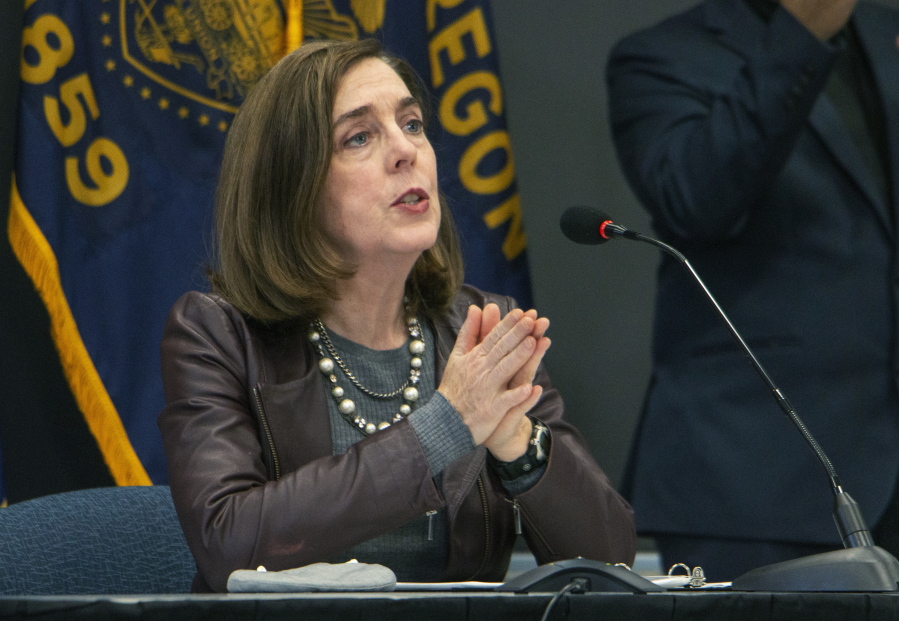 FILE - Oregon Gov. Kate Brown speaks on Nov. 10, 2020, in Portland, Ore. Brown is defending granting clemency to dozens of people, including for a man convicted of murdering a teenager and whose release from prison is coming under fire from prosecutors and sheriffs.