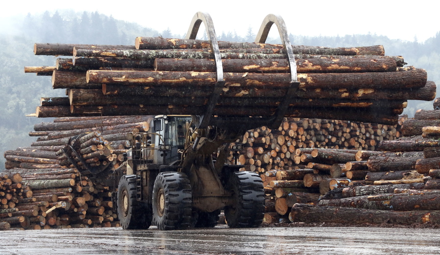 FILE - In this Feb. 26, 2015 photo, a front end log loader transports logs at Swanson Group Manufacturing in Roseburg, Ore. The Oregon Court of Appeals on Wednesday, April 27, 2022, overturned a $1.1 billion verdict against the state over its forest management practices, the latest development in a decades-long dispute over the best use of vast tracts of forestland that cover much of the state's rural areas.