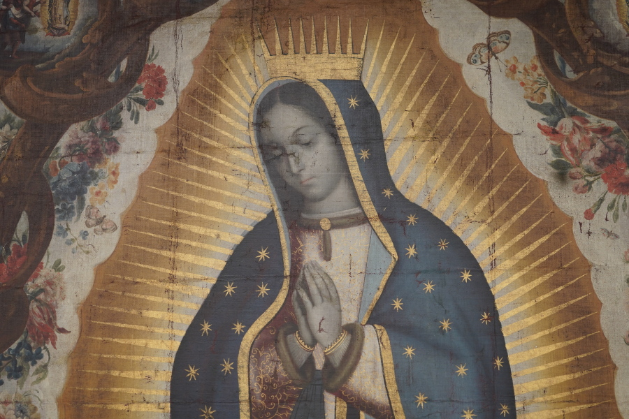 Vertical and horizontal fold lines are left on the canvas of the "Virgin of Guadalupe" painting after it was stolen from the Santiago Apostle Church in Ollantaytambo, Peru, in 2002. The painting, now recovered, is shown Friday at the FBI headquarters in Los Angeles.
