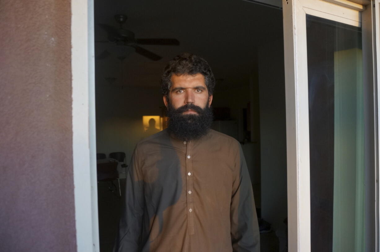Wolayat Khan Samadzoi watches through the open balcony door of his apartment for the sliver of new moon to appear in the cloudless sky, where the sun had set beyond a desert mountain, in Las Cruces, N.M., Saturday, April 2, 2022. Samadzoi and thousands of other Afghans evacuated to the United States as the Taliban regained power last summer are celebrating their first Muslim holy month of Ramadan here - grateful to be safe, but agonizing over their families back home under the repressive Taliban regime.