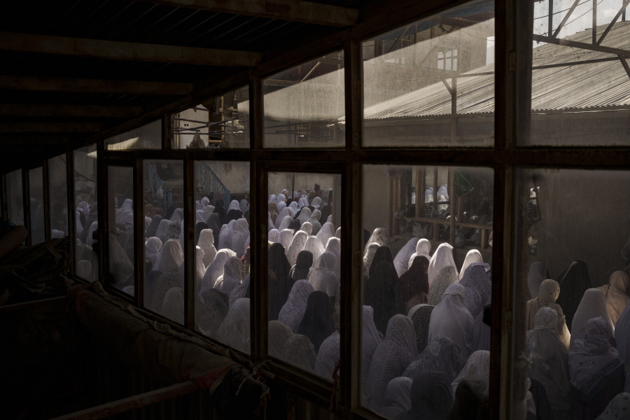 FILE - Women pray in a Shiite mosque during Friday prayers in Kabul, Afghanistan, Friday, Oct. 8, 2021. Afghanistan should join a list of the "worst of the worst" violators of religious freedom in the wake of the Taliban's return to power, a U.S. advisory body is recommending to the State Department in its annual report released on Monday, April 25, 2022.