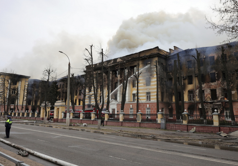 Firefighters hose down the burning building of the Central Research Institute of the Aerospace Defense Forces in the Russian city of Tver, Russia, Thursday, April 21, 2022. The press service of the local administration announced later in a statement that six people were killed and at least 27 were injured and over 10 people may be still trapped inside the building.
