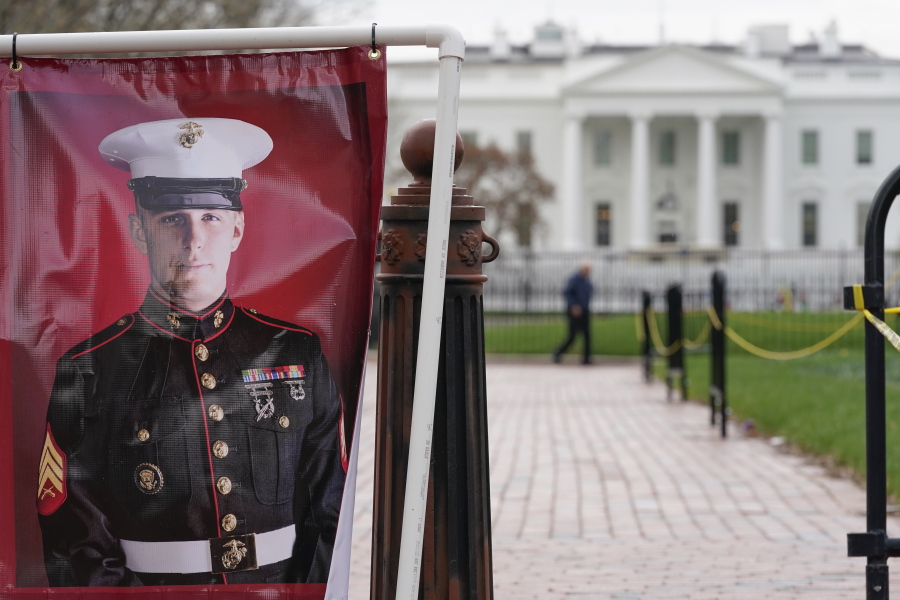 FILE - A poster photo of U.S. Marine Corps veteran and Russian prisoner Trevor Reed stands in Lafayette Park near the White House, March 30, 2022, in Washington.