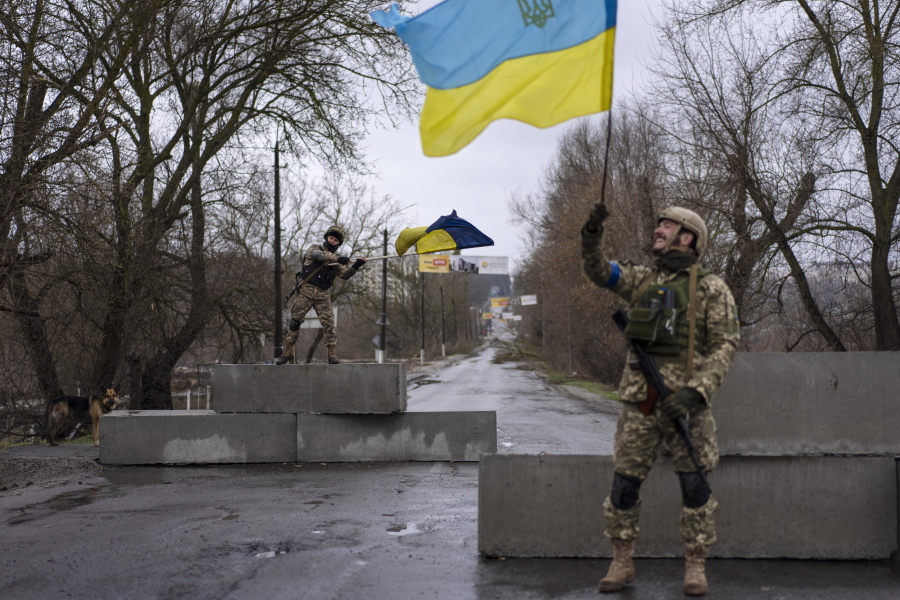 FILE - Ukrainian soldiers celebrate at a check point in Bucha, in the outskirts of Kyiv, Ukraine, April 3, 2022. Kyiv was a Russian defeat for the ages. It started poorly for the invaders and went downhill from there.