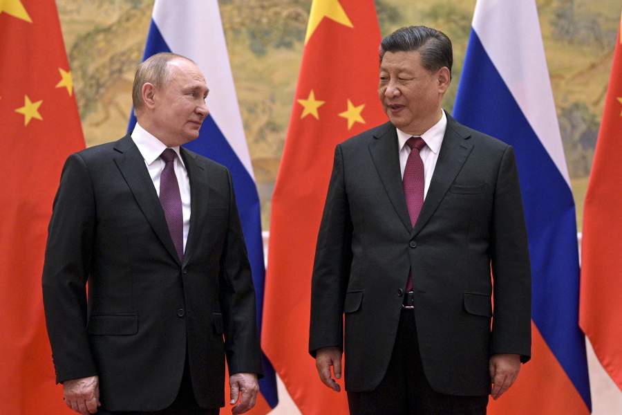 FILE - Chinese President Xi Jinping, right, and Russian President Vladimir Putin talk during their meeting in Beijing, China, Friday, Feb. 4, 2022. With Russia's military failings in Ukraine mounting, no country is paying closer attention than China to how a smaller, outgunned force has badly bloodied what was thought to be one of the world's strongest armies.