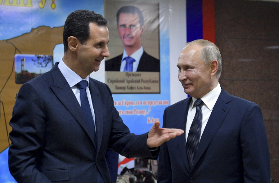 FILE - Syrian President Bashar Assad, left, gestures while speaking to Russian President Vladimir Putin during their meeting in Damascus, Syria, Jan. 7, 2020. The next chapter of the war in Ukraine could see Russia bringing in greater numbers of battle-hardened fighters from Syria, observers say.