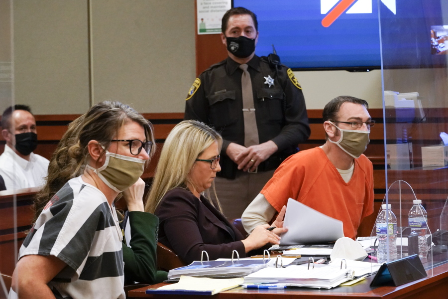 FILE - Jennifer Crumbley, left, and James Crumbley, right, the parents of Ethan Crumbley, a teenager accused of killing four students in a shooting at Oxford High School, appear in court for a preliminary examination on involuntary manslaughter charges in Rochester Hills, Mich. on Feb. 8, 2022. The Crumbleys return to court, Tuesday, March 22, for a pretrial hearing on involuntary manslaughter charges.