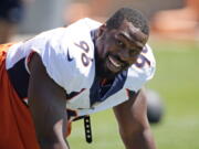 FILE- Denver Broncos defensive end Shelby Harris jokes with teammates as they take part in drills during NFL football training practice at the team's headquarters on Aug. 25, 2021, in Englewood, Colo. For both Shelby Harris and Noah Fant, their unexpected offseason move joining the Seattle Seahawks feels a bit like an eventuality finally coming true.