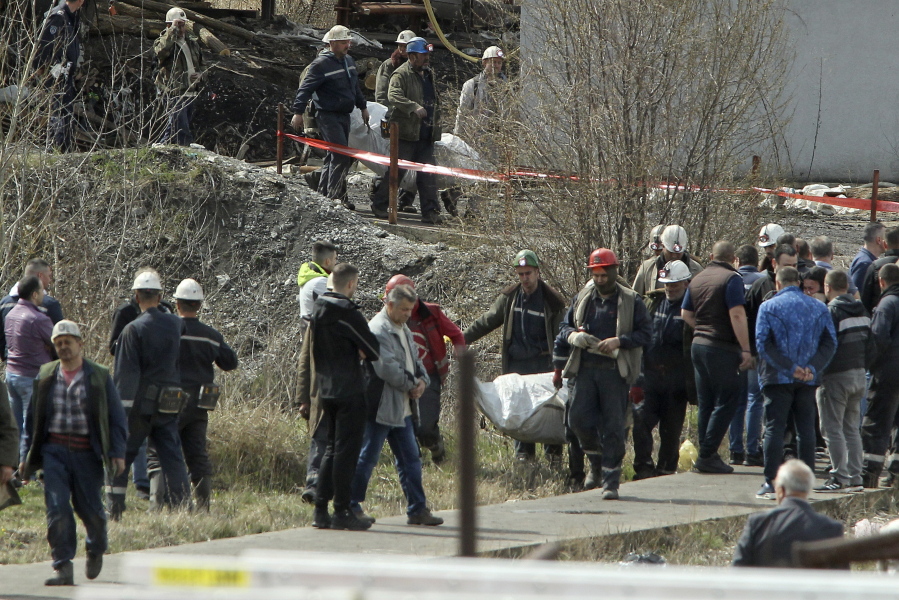 Rescue workers carry a body after a shaft collapsed in Soko coal mine, in central Serbia, Friday, April 1, 2022. Serbian authorities say that an accident in a mine in central Serbia has killed 8 people and wounded 18. The Soko mine, about 200 kilometers (125 miles) southeast of Belgrade, has had several serious accidents since it started operating in the early 1900s. An accident in the mine in 1998 killed 29 miners.