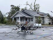 A power pole ripped from its location lies on the street Tuesday in Pembroke, Ga., after a storm damaged several homes and the Bryan County Courthouse. Pembroke is 30 miles from Savannah, Ga. (Lewis M.