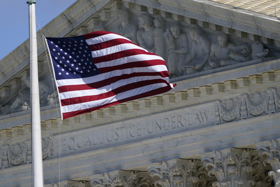 FILE - An American flag waves in front of the Supreme Court building, Nov. 2, 2020, on Capitol Hill in Washington.