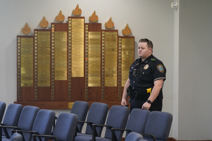 A police officer stands by during a media tour of Congregation Beth Israel in Colleyville, Texas, Thursday, April 7, 2022. Three months after an armed captor took the three men hostage at the synagogue, the house of worship is reopening.