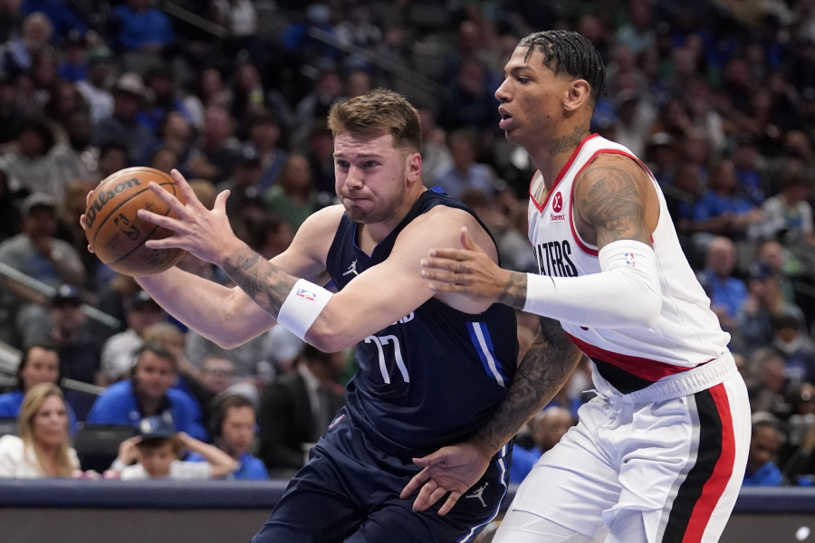 Dallas Mavericks guard Luka Doncic (77) drives to the basket against Portland Trail Blazers forward Didi Louzada during the first half of an NBA basketball game Friday, April 8, 2022, in Dallas.