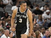 San Antonio Spurs' Keldon Johnson celebrates after a basket during the first half of an NBA basketball game against the Portland Trail Blazers on Sunday, April 3, 2022, in San Antonio.