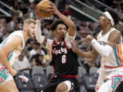 Portland Trail Blazers guard Keon Johnson (6) drives to the hoop as San Antonio Spurs guard Josh Richardson, right, defends during the first half of an NBA basketball game Friday, April 1, 2022, in San Antonio.