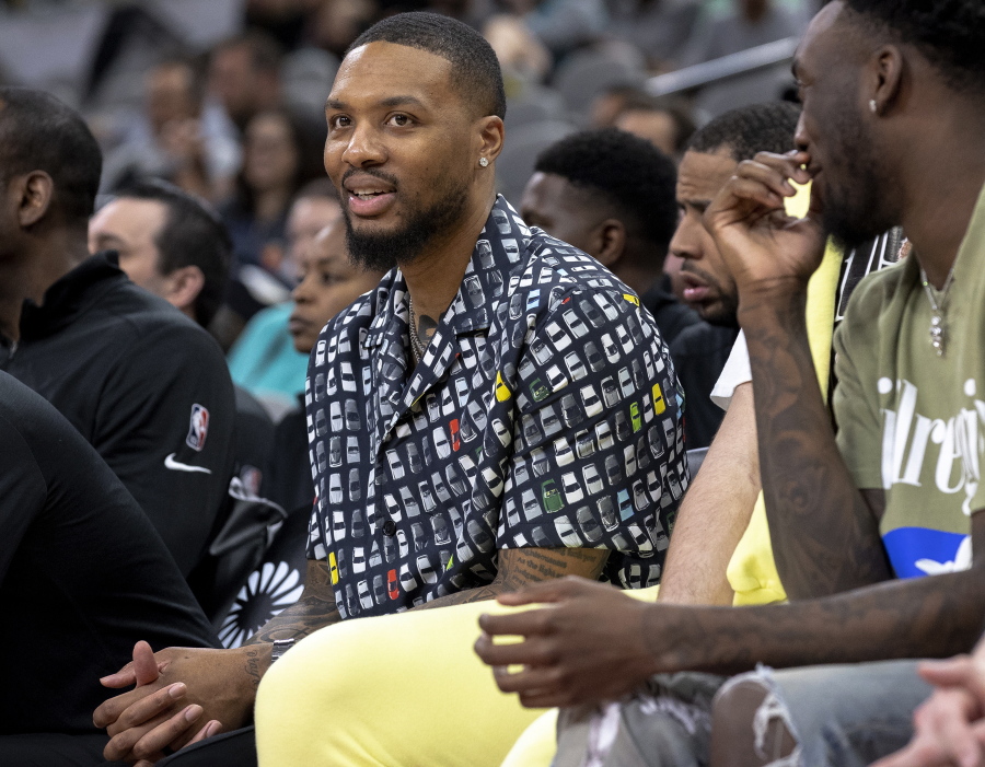 Portland Trail Blazers guard Damian Lillard sits on the bench during the second half of the team's NBA basketball game against the San Antonio Spurs on Friday, April 1, 2022, in San Antonio. Lillard is injured and out for the remainder of the season.