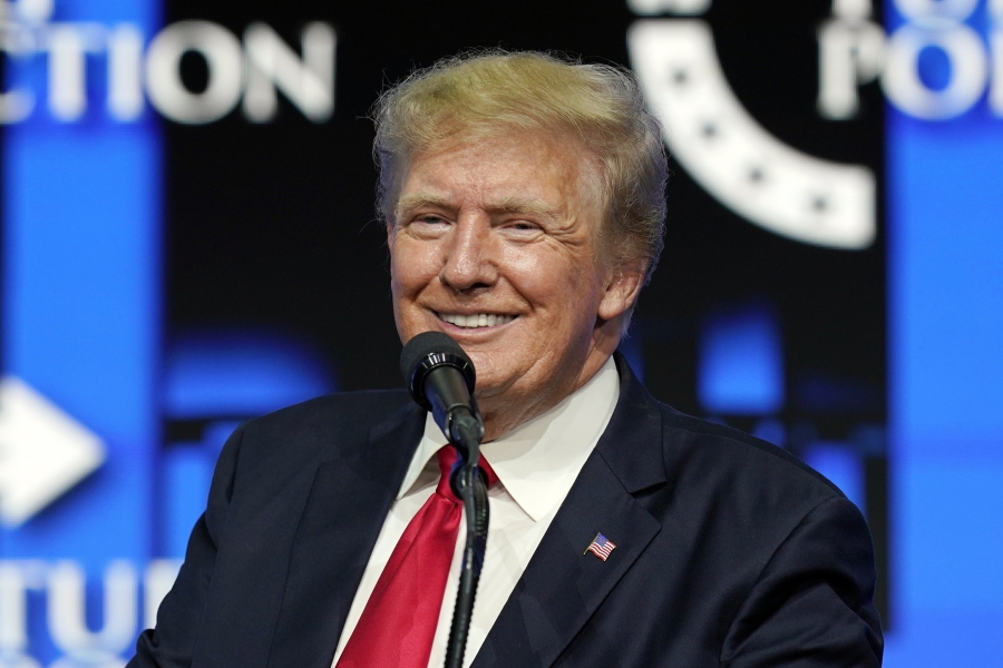FILE - In this July 24, 2021, file photo former President Donald Trump smiles as he pauses while speaking to supporters at a Turning Point Action gathering in Phoenix. Stock in a company planning to buy Trump's new social media business plunged Monday, April 4, 2022 on a news report that two key staff members left and a regulatory filing that it will miss a key deadline to file its annual financial statements. (AP Photo/Ross D.