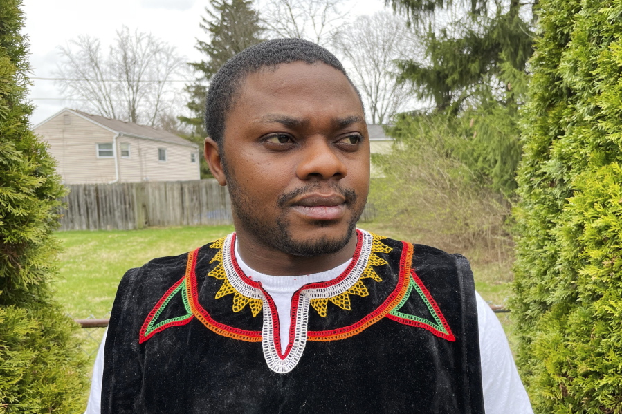 Wilfred Tebah, who fled Cameroon during its ongoing conflict, poses for a photo in the backyard of his home, Thursday, March 31, 2022, in Columbus, Ohio. African refugees say the recent decision to grant Ukrainians fleeing war refugee status and other humanitarian protections underscores the racial bias inherent in American immigration policy. Tebah says he and other immigrants from Cameroon have long been deserving of similar humanitarian considerations.