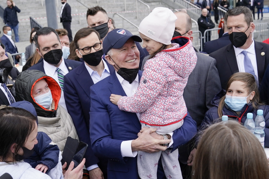 FILE - President Joe Biden meets with Ukrainian refugees during a visit to PGE Narodowy Stadium, March 26, 2022, in Warsaw. The Biden administration is making it easier for refugees fleeing Russia's war on Ukraine to come to the United States from Europe while trying to shut down an informal route through Northern Mexico that has emerged in recent weeks.