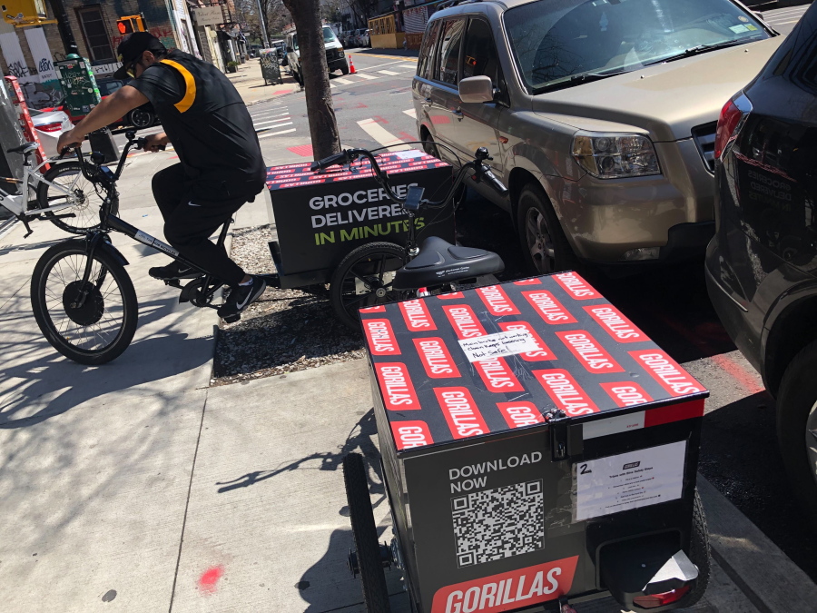 A worker sets to make a delivery on a bicycle in front of Gorillas mini-warehouse in the Williamsburg section of the Brooklyn borough of New York on Monday, April 12, 2022.   Gorillas is one of several companies that venture capitalists have poured billions into in the latest pandemic delivery craze.They typically deliver from mini-warehouses in residential and commercial neighborhoods.