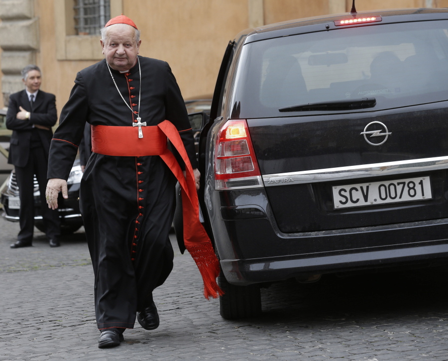 FILE - Cardinal Stanislaw Dziwisz arrives for a meeting at the Vatican, Friday, March 8, 2013. A Vatican investigation into allegations that Dziwisz, the former top aide to St. John Paul II was negligent in handling sex abuse claims in his native Poland has cleared him of wrongdoing, the Vatican's embassy in Poland said Friday, April 22, 2022.