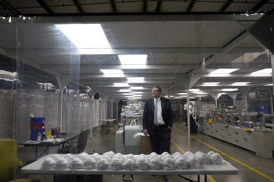 Jim Schmersahl, owner of Halcyon Shades, poses in a "clean room" used in making N-95 masks at the company's production facility Friday, March 18, 2022, in University City, Mo. Halcyon is small company that normally makes window shades, but when the pandemic hit, its sales plummeted. Halcyon applied for the state grants to make PPE as a way to try to keep its employees at work and keep the company afloat.