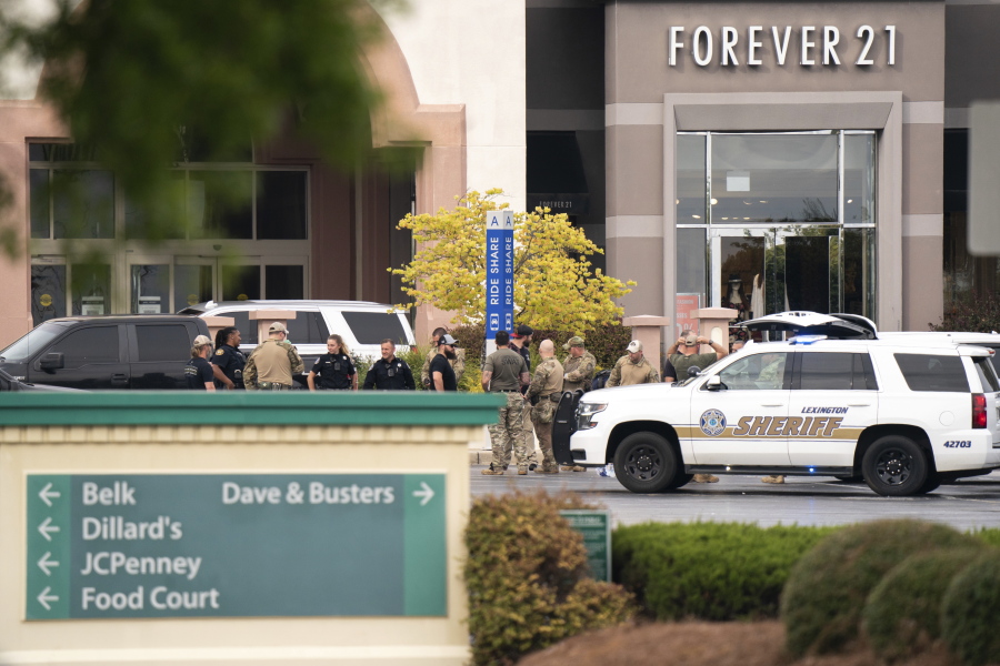 FILE - Members of law enforcement gather outside Columbiana Centre mall in Columbia, S.C., following a shooting, April 16, 2022. Authorities in South Carolina say they are investigating shooting at a club in Hampton County early Sunday, April 17, 2022 that left at least nine people injured. It was the second mass shooting in the state in as many days.
