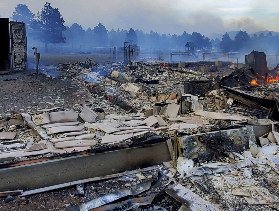 This Wednesday April 20, 2022, photo provided by Bill Wells shows his home on the outskirts of Flagstaff, Ariz., destroyed by a wildfire on Tuesday, April 19, 2022. The wind-whipped wildfire has forced the evacuation of hundreds of homes and animals.