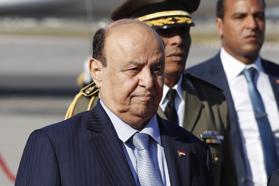 FILE - Yemen's President Abed Rabbo Mansour Hadi walks next of his Tunisian counterpart Beji Caid Essebsi, not in photo, upon his arrival at Tunis-Carthage international airport to attend the Arab Summit, in Tunis, Tunisia, March 30, 2019.