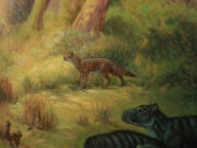 This painting at the San Diego Natural History Museum shows what the Archeocyons canid, center, would have looked like during the Oligocene era in what's now San Diego.