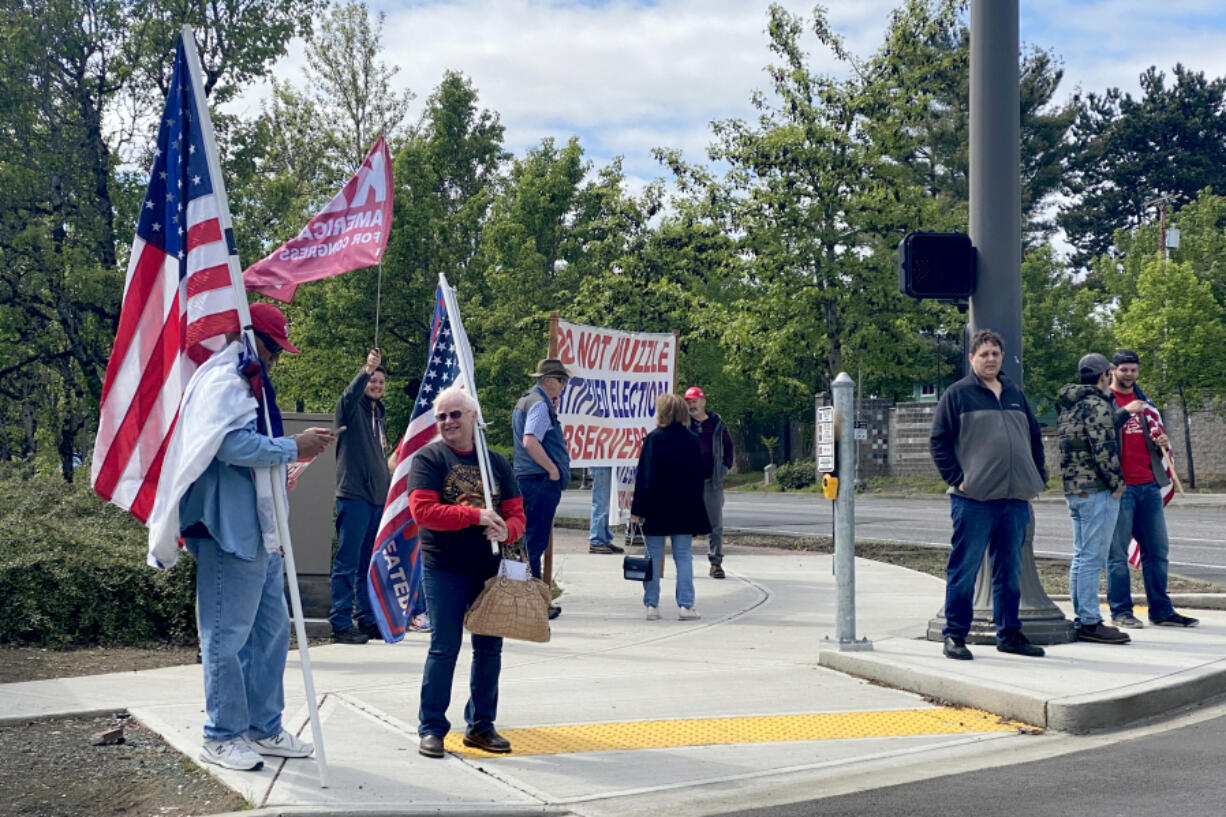 Around a dozen protesters stand outside the Clark County Elections Office on Tuesday afternoon in support of Ed O'Meara. O'Meara was appealing his December ousting as an elections observer.