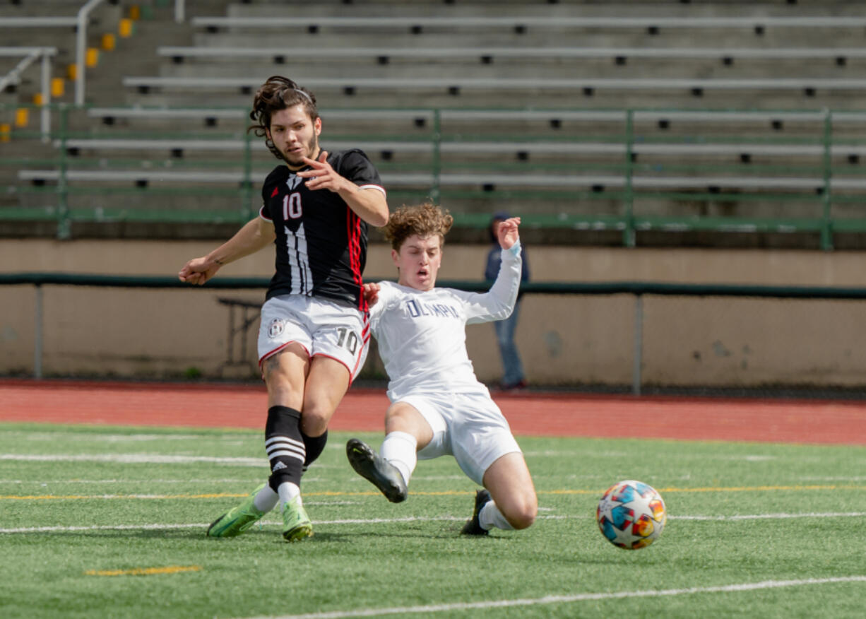 Union's Isaiah Bunda shoots and scores the game's only goal past an outstretched Olympia defender in a 4A District 3/4 boys soccer game on Saturday, May 7, 2022, at McKenzie Stadium. Union beat Olympia 1-0 to secure its first state berth since 2016.